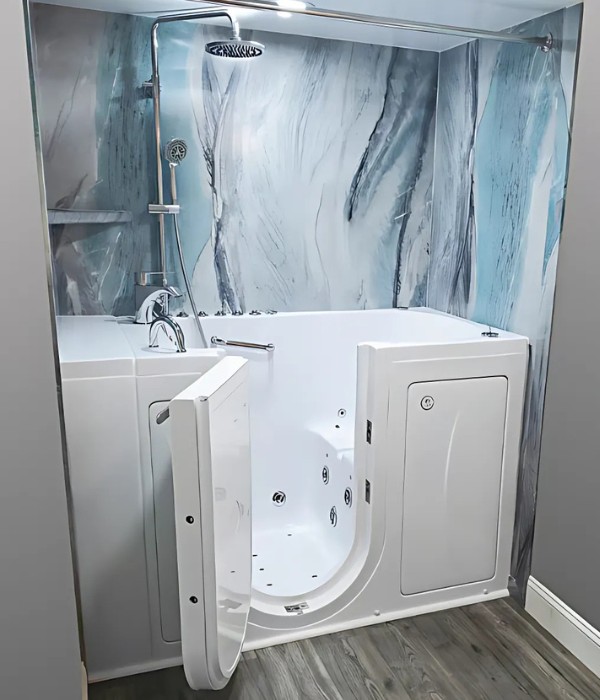 White walk in bathtub with door open jets visible and blue marble wall surround