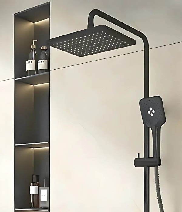 Matte black square rainfall shower with matching handheld sprayer beside a recessed lit shelf in a modern bathroom