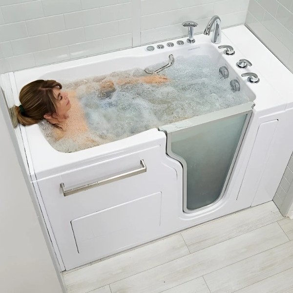 Woman relaxing in a white walk in bathtub with bubbling hydrotherapy jets and a clear side door